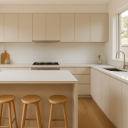 Modern kitchen with a bright white engineered stone benchtop and waterfall island edge
