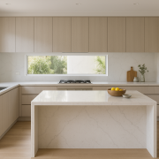 Kitchen island with Essastone-style white veined benchtop and waterfall end