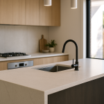 Modern kitchen with engineered stone island benchtop and waterfall end