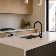 Modern kitchen with engineered stone island benchtop and waterfall end