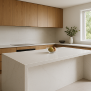 White engineered stone kitchen island benchtop with waterfall edge in a bright Australian kitchen
