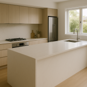 Modern kitchen with light engineered stone benchtop and waterfall island edge