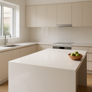 Modern kitchen with a white quartz benchtop and waterfall island edge